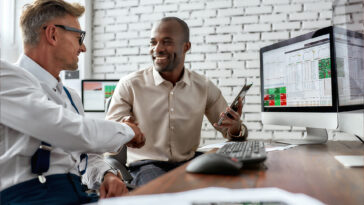 Two men shaking hands on an equity investment deal
